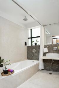 班加罗尔鲁克斯君主酒店 - 因凡特里路的带浴缸和盥洗盆的浴室