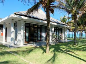 潘切Starlight Villa Beach Resort & Spa的前面有棕榈树的房子