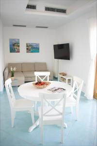 圣安吉洛Fountain House Sorrento的白色的客厅配有白色的桌子和椅子