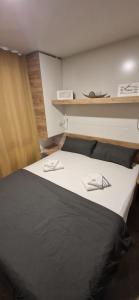 耶泽拉Mobile Homes Albatross的一间卧室配有一张带玻璃杯的大床
