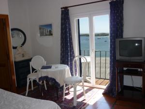 卡达克斯利加特港酒店的一间卧室设有一张床和一个海景阳台