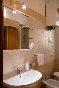 巴勒莫Hola Cathedral House的一间带水槽、镜子和卫生间的浴室