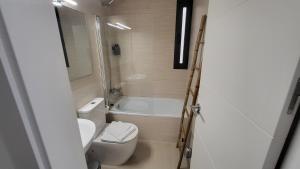 塞维利亚RentalSevilla La Salle的浴室配有卫生间、盥洗盆和浴缸。