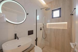 萨兰达Villa Xhefri的浴室设有白色水槽和镜子