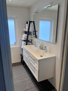 哈尔姆斯塔德Villa, Barnvänlig, nära strand/shopping的白色的浴室设有水槽和镜子