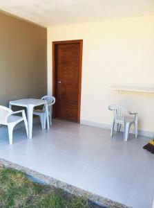 古里里Casa Luxo e Sossego 50m da Praia的一个带桌椅和门的庭院
