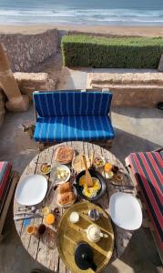 AghnajaneMomo's beach house的海滩旁的餐桌上摆着早餐食品