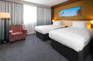 德比假日德比河光酒店的酒店客房,配有两张床和椅子