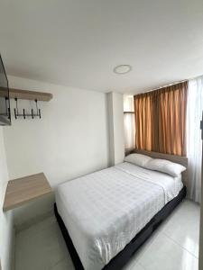 马尼萨莱斯Hotel Adel的一间小卧室,配有床和窗户