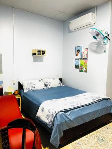 Cao LãnhMOCA MOTEL的一间卧室配有一张床和一张红色椅子