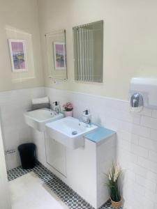 斯特灵William Wallace Hotel的白色的浴室设有两个盥洗盆和镜子