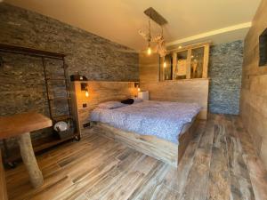AfaChambres du Gozzi的一间卧室配有一张床,铺有木地板