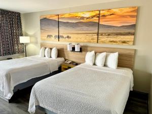 范霍恩范霍恩戴斯酒店的酒店客房设有两张床,墙上挂有绘画作品