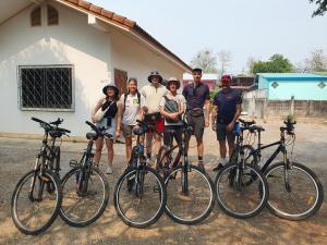 素可泰Perfect Resort Sukhothai & motorbikes for rent & bicycles for rent的一群人站在自行车旁边