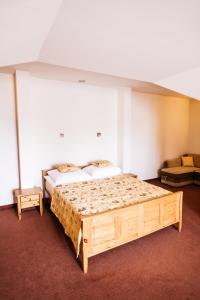 梅斯瓦科维采查塔扎维希亚酒店的一间卧室配有一张大床和一张沙发