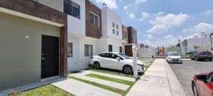 克雷塔罗Casa con alberca Mirador SD的停在大楼前的白色汽车