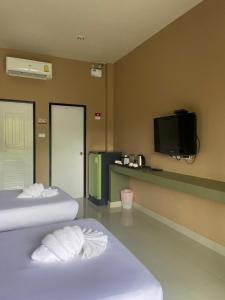 甲米镇Infinite Resort and Cafe的酒店客房设有两张床和一台平面电视。