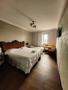 马瑙斯塞林伽酒店的一间卧室设有两张床和窗户。