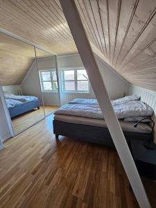 希恩Sentrumsnær enebolig med 4 soverom的一间卧室设有两张床和木制天花板
