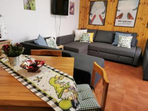 FaidelloLa Casetta degli Gnomi的客厅配有桌子和沙发