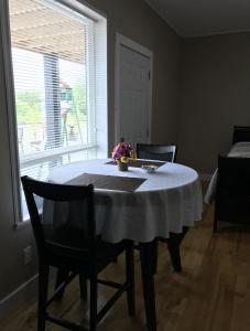尤克卢利特Pacific Rim Guest Lodge - Adults Only的一张桌子上放着白色桌布和鲜花