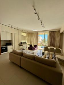 希马拉Villa Splendid Palase的一间带大沙发的客厅和一间厨房