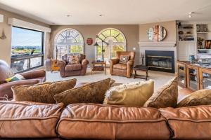 圣地亚哥Spacious Beautiful Home with Stunning Bay Views的客厅设有棕色沙发和壁炉