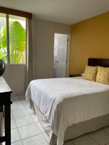 危地马拉Inari Hostal的一间卧室设有一张大床和窗户