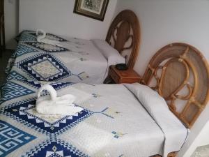 阿卡普尔科Hermosa Suite en Acapulco的两张睡床,在房间内有天鹅