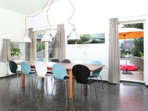 OlstCozy Holiday Home in Olst Wijhe with swimming pool的一间带木桌和椅子的用餐室