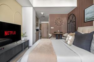 迪拜GuestReady - Urban Retreat in Downtown的酒店客房,配有床和电视