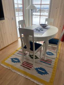 雷克桑德Tällberg, utsikt över Siljan的地毯上的白色餐桌和椅子