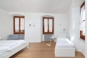 加尔达湖滨Casa Morellato的带两张床和两个窗户的房间