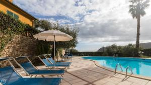 菲纳莱利古雷Italianway - Il Borgo apartments的一个带蓝色椅子和遮阳伞的游泳池