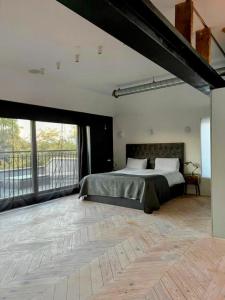 伦敦Remarkable 7-Bed House in London的一间带大床的卧室和一个阳台