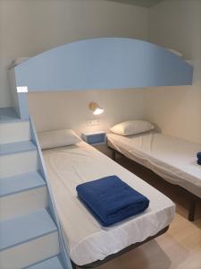 托里代巴拉Camping Relax Sol的小房间设有两张床和楼梯