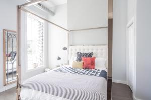 卡温顿Cute & Cozy - Perfect for Business or Leisure的白色卧室配有带红色枕头的天蓬床