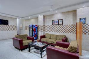 马杜赖OYO Hotel Radhakrishna的一间配有沙发和桌子的房间