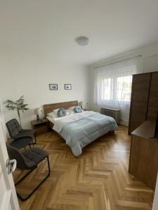 巴拉顿博格拉尔Attila Vendégház的一间卧室配有一张大床和一把椅子