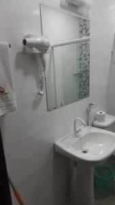 乌巴图巴Pousada Mar Suites Toninhas的白色的浴室设有水槽和镜子