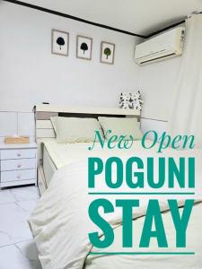 首尔[New]Seongsu/Konkuk U/PoguniStay的一间卧室,配有床和奥伦客房住宿标志