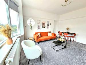 格拉斯哥Charming 3-Bed Oasis-free parking的客厅配有橙色沙发和桌子