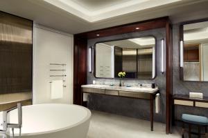 青岛青岛瑞吉酒店的一间带浴缸和大镜子的浴室