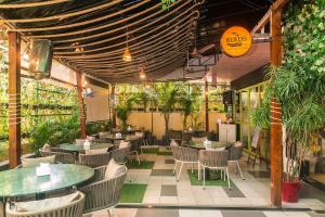 孟买Hotel Orritel West的一间设有桌椅的餐厅,种植了植物