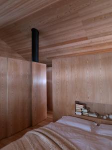 圣维吉利奥Mountain Lodge Tamersc的一间卧室设有一张木天花板床。