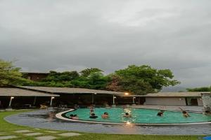 乌代浦Banjara Hills Jungle Lodge的一群人在游泳池里