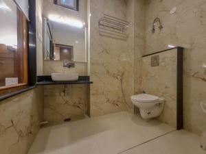马拉里The Shivi Palace的一间带卫生间、水槽和镜子的浴室