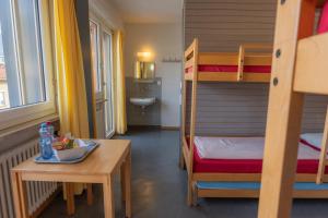 洛迦诺洛迦诺青年旅舍的客房设有一张桌子和一张双层床。