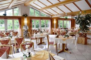 苏尔茨巴赫-罗森贝格嘎斯霍夫福斯索夫酒店的餐厅设有白色的桌椅和窗户。