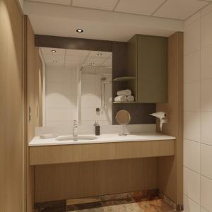 滨海韦克霍格杜茵酒店的一间带水槽和镜子的浴室